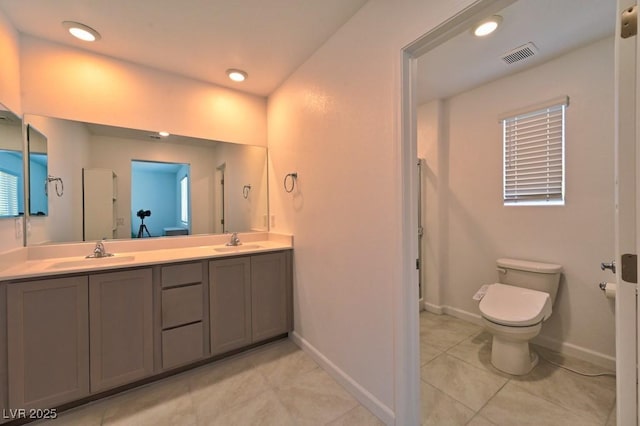 bathroom featuring tile patterned flooring, vanity, and toilet