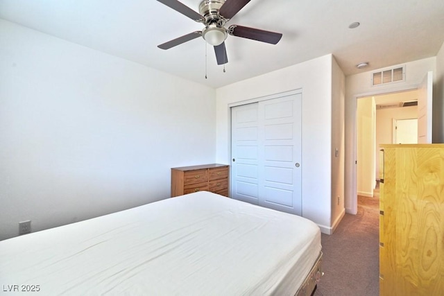 carpeted bedroom with ceiling fan and a closet