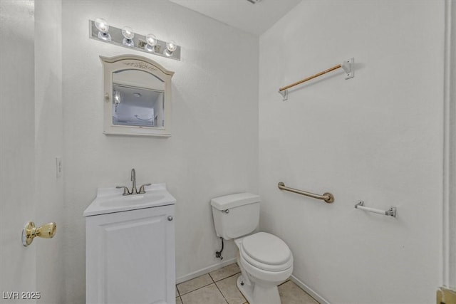 bathroom featuring vanity, tile patterned floors, and toilet