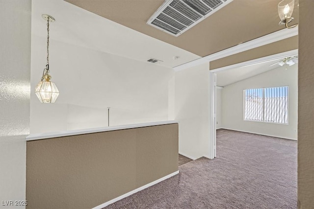 hall with lofted ceiling and carpet