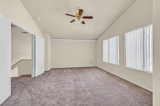 empty room with lofted ceiling, light carpet, and ceiling fan