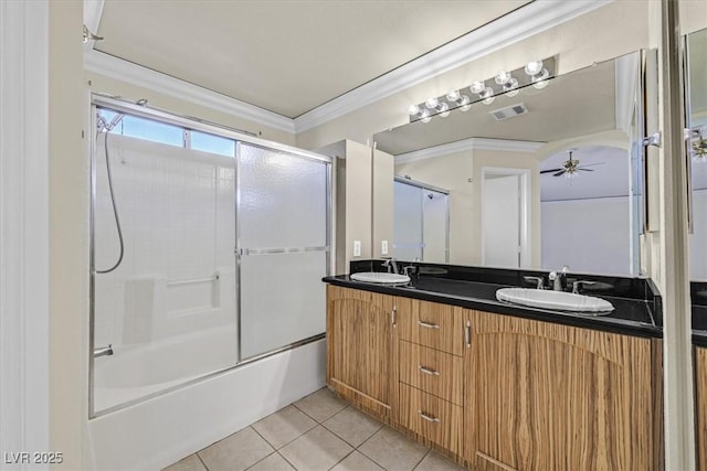 bathroom with combined bath / shower with glass door, ceiling fan, tile patterned flooring, vanity, and ornamental molding