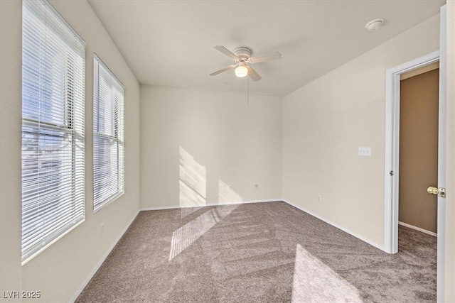 unfurnished room with ceiling fan and carpet flooring