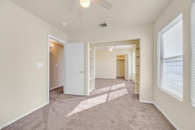 carpeted spare room with ceiling fan