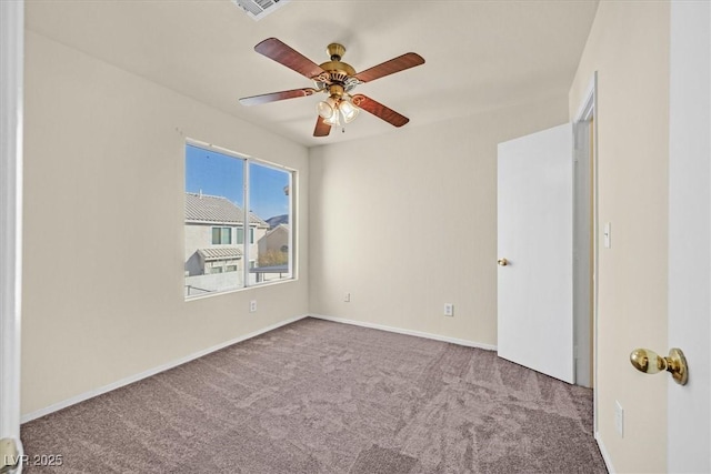 carpeted spare room with ceiling fan