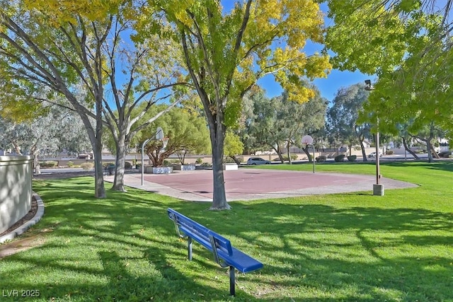 view of home's community with a yard and basketball court