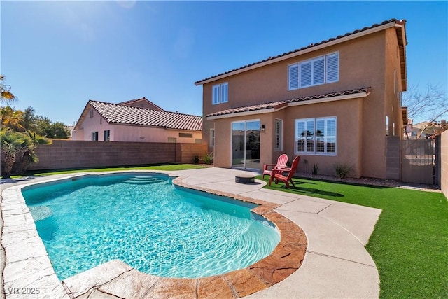 view of swimming pool with a lawn and a patio