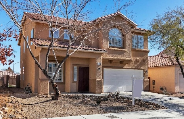 mediterranean / spanish home with a garage