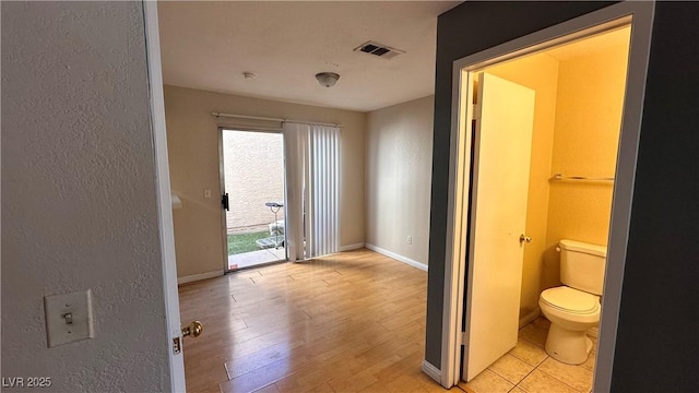 bathroom featuring hardwood / wood-style floors and toilet