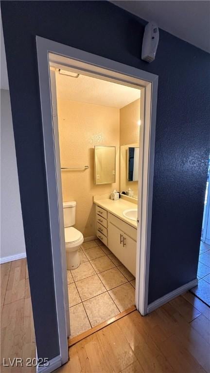 bathroom with vanity, hardwood / wood-style floors, and toilet