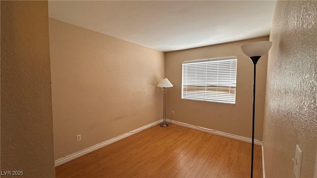 spare room featuring hardwood / wood-style flooring