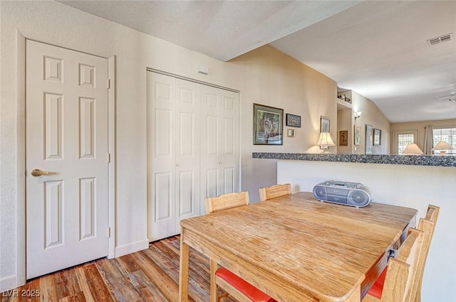 dining space featuring wood-type flooring