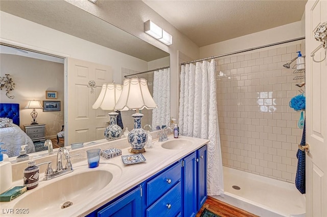 bathroom featuring vanity, a textured ceiling, and walk in shower