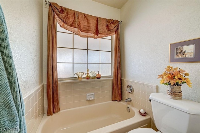 bathroom featuring toilet and a bath