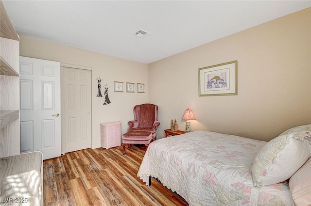 bedroom with hardwood / wood-style flooring