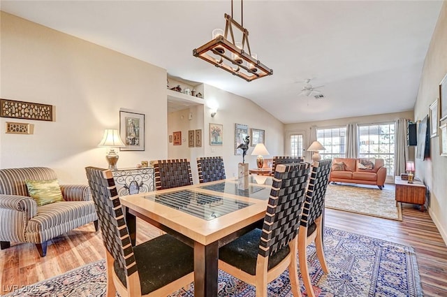 dining area featuring lofted ceiling, hardwood / wood-style floors, and ceiling fan