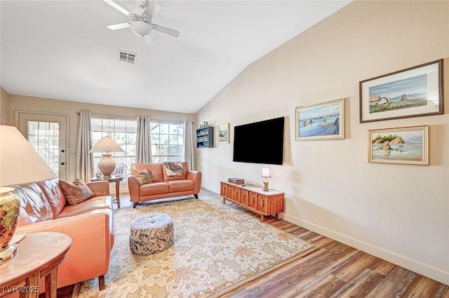 living room with lofted ceiling, hardwood / wood-style floors, and ceiling fan