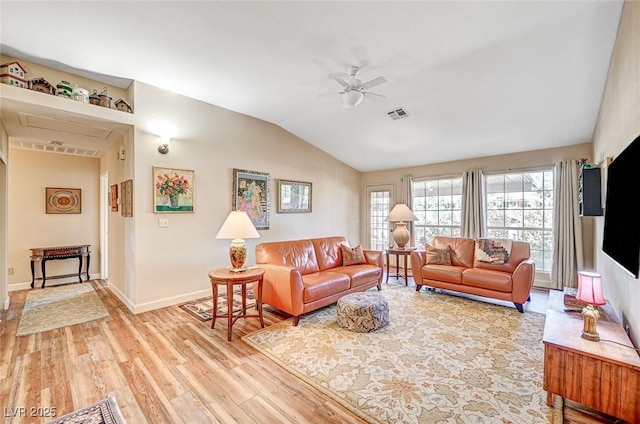 living room featuring ceiling fan, lofted ceiling, and light wood-type flooring