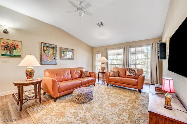 living room with hardwood / wood-style flooring, lofted ceiling, and ceiling fan