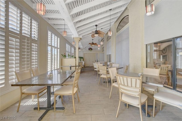 dining space with ceiling fan, plenty of natural light, and high vaulted ceiling