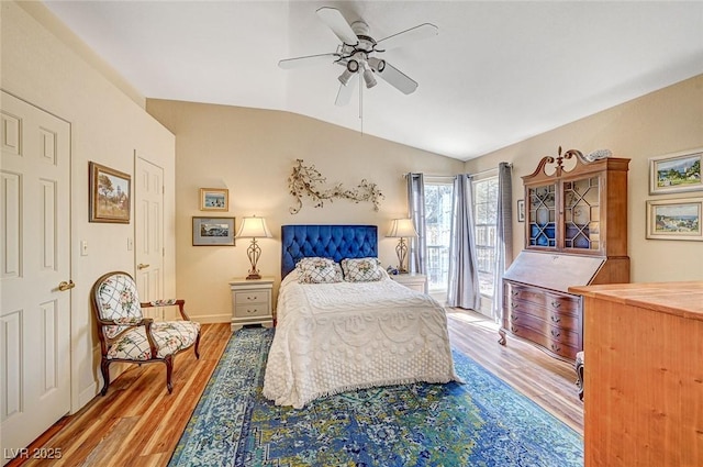 bedroom featuring vaulted ceiling, access to outside, ceiling fan, and light wood-type flooring