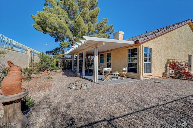 back of property with a patio