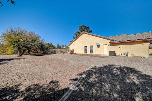 rear view of property with central air condition unit