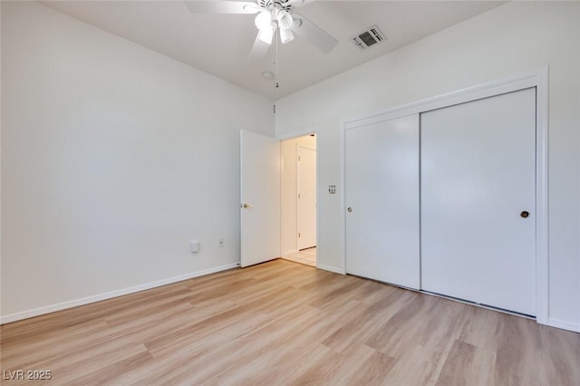 unfurnished bedroom featuring a closet, visible vents, light wood-style flooring, a ceiling fan, and baseboards