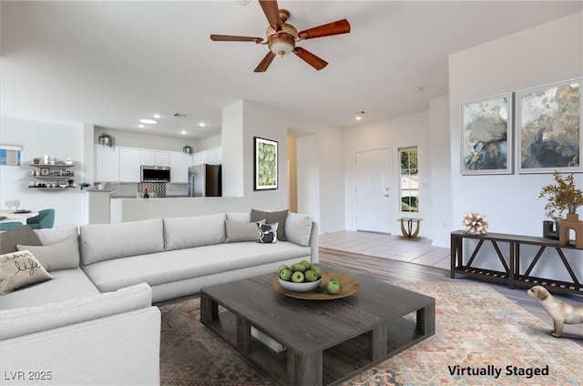 living room featuring light wood-type flooring, visible vents, and recessed lighting