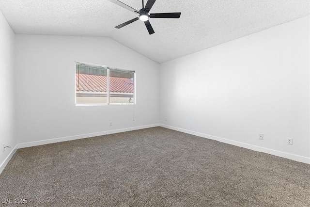 unfurnished room with ceiling fan, vaulted ceiling, carpet, and a textured ceiling