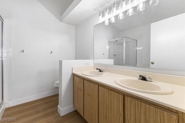 bathroom with walk in shower, wood-type flooring, toilet, and vanity