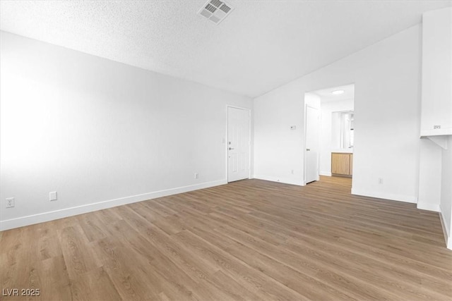 unfurnished living room with hardwood / wood-style floors and a textured ceiling