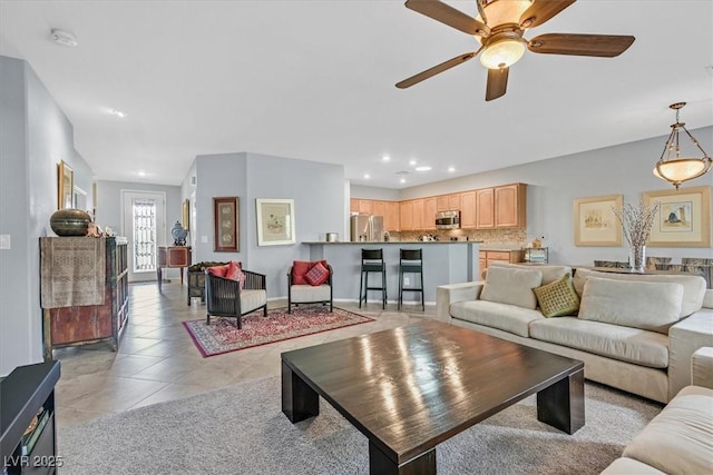 tiled living room with ceiling fan