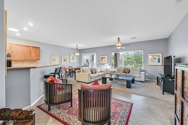 living room featuring ceiling fan and light tile patterned floors