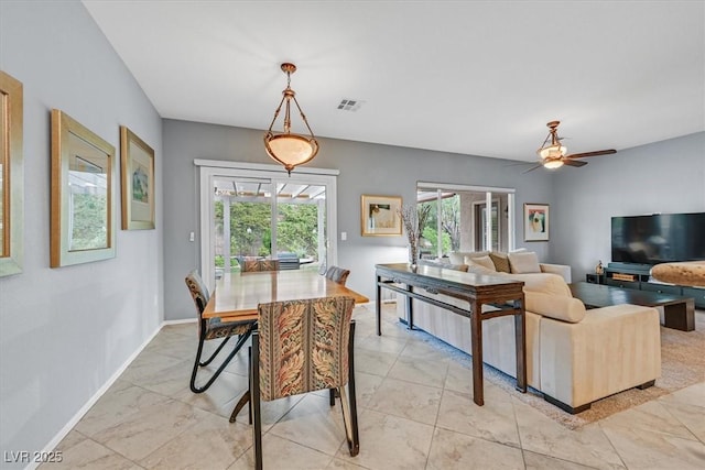 dining space featuring ceiling fan and a healthy amount of sunlight