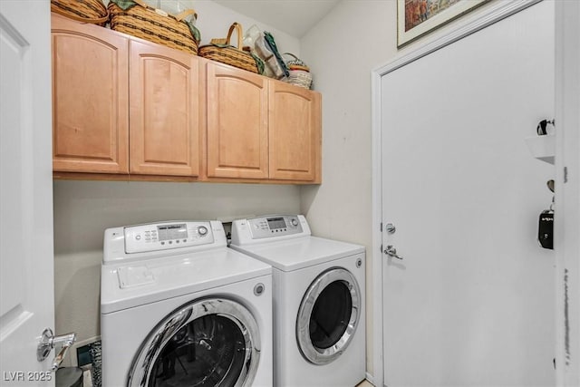 laundry area with cabinets and washing machine and dryer