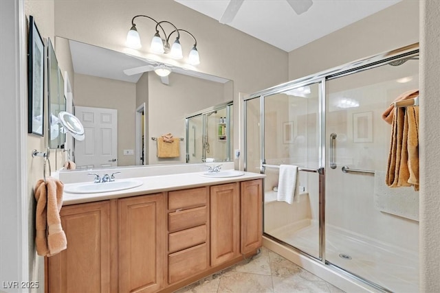 bathroom with vanity, ceiling fan, and a shower with shower door