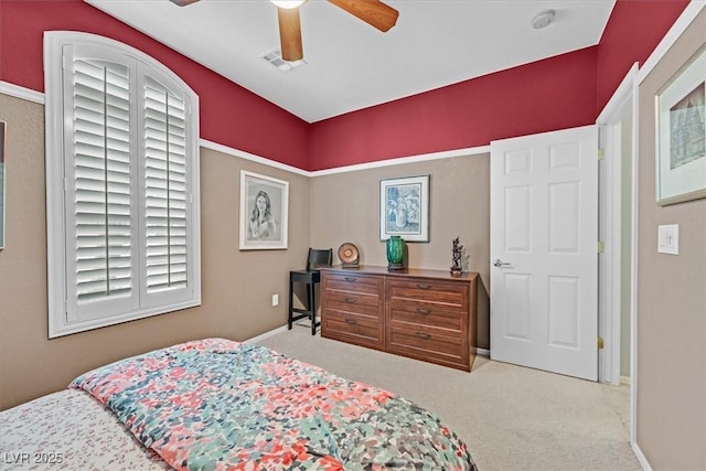 bedroom with ceiling fan and light carpet