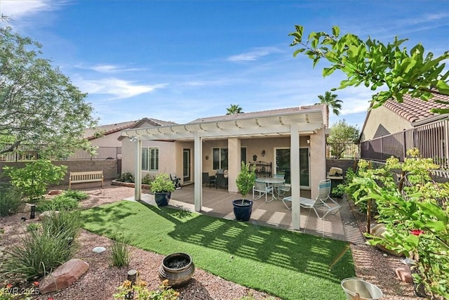 back of house featuring a lawn, a patio area, and a pergola