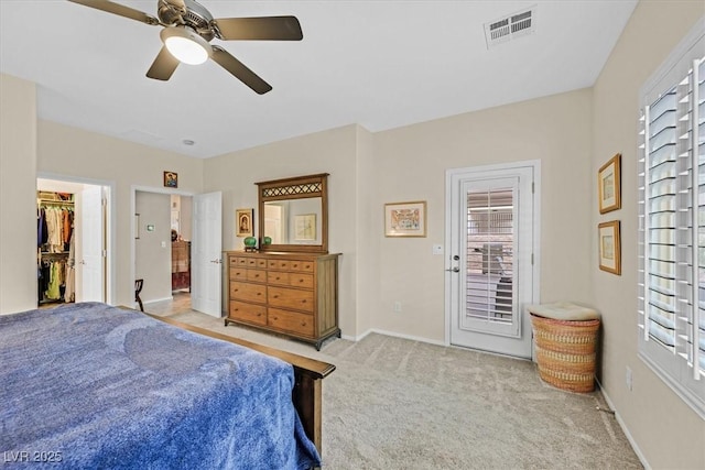 carpeted bedroom with ceiling fan, access to exterior, and multiple windows