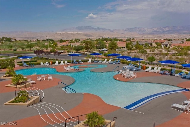 view of pool with a patio and a mountain view