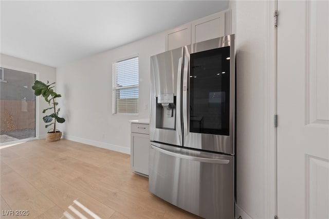 kitchen with white cabinetry, stainless steel fridge with ice dispenser, and light wood-type flooring