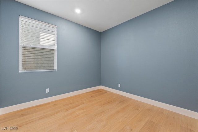 empty room with hardwood / wood-style flooring