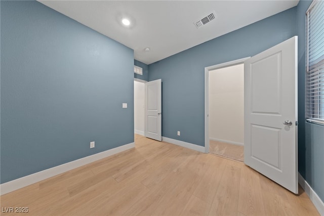 unfurnished bedroom with light wood-type flooring