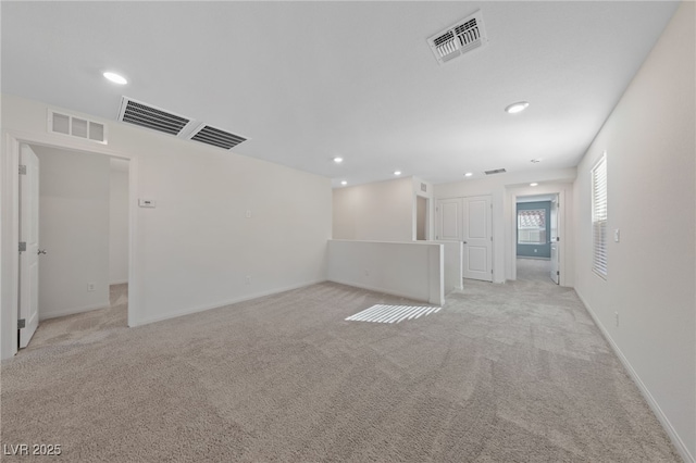 unfurnished room featuring light colored carpet