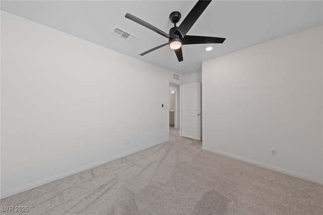 carpeted spare room featuring ceiling fan