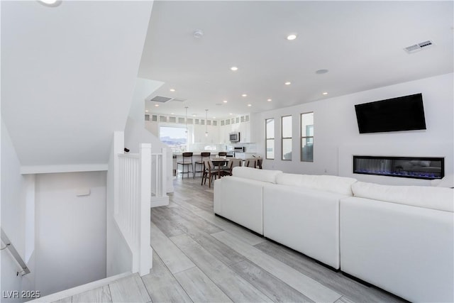 living room with light hardwood / wood-style flooring