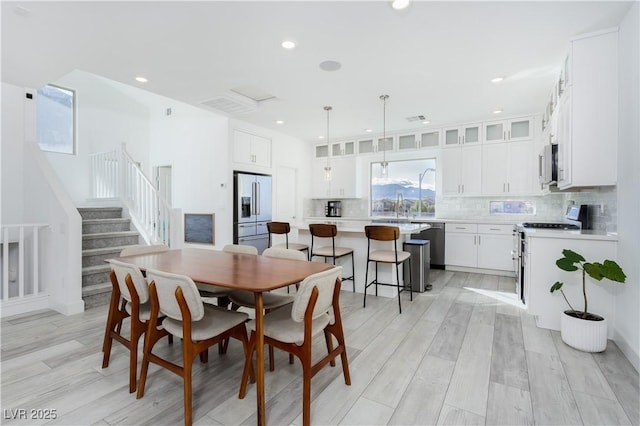 dining room featuring sink and light hardwood / wood-style floors