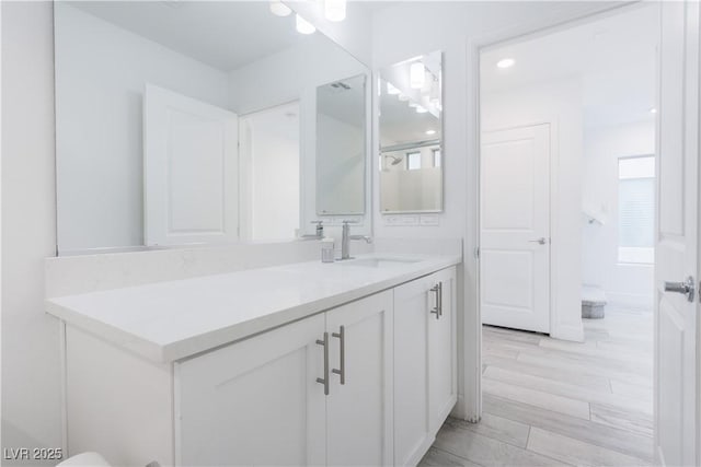 bathroom with vanity and hardwood / wood-style floors