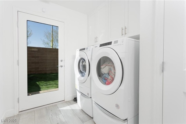 laundry room featuring cabinets and separate washer and dryer